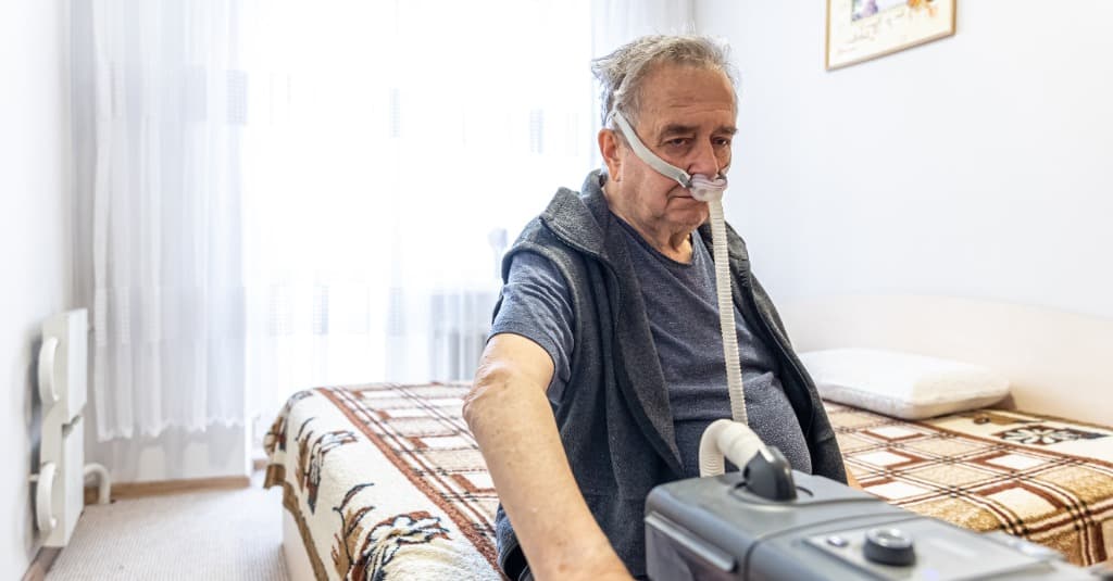 Home health nurse providing respiratory care
