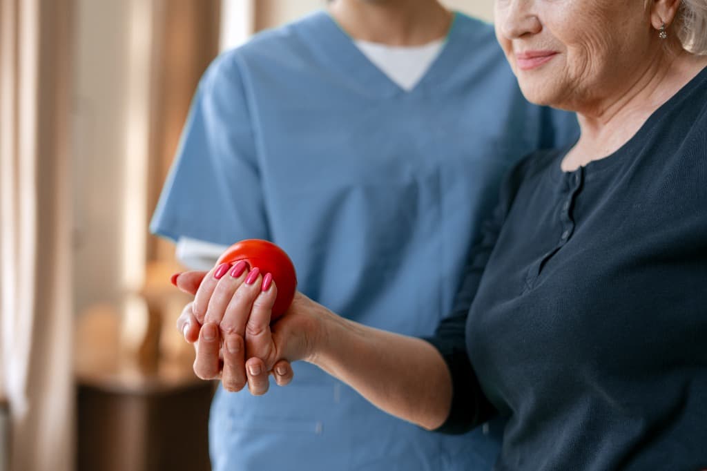 Caregiver supporting physical rehabilitation and daily activities